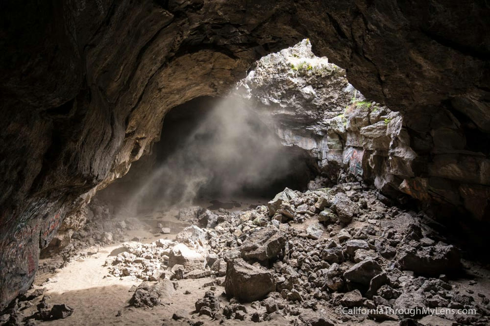 Sunlight and drifting mist in the rocky interior of Pluto’s Cave